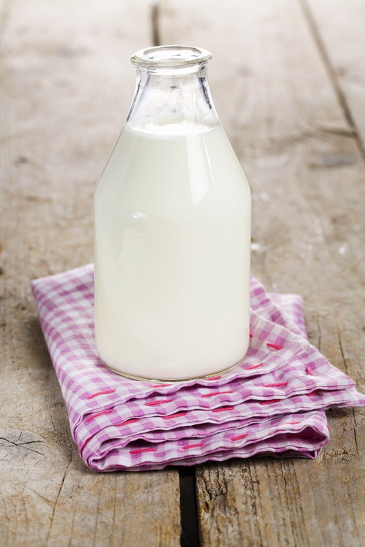 Bottle of milk on checked cloth