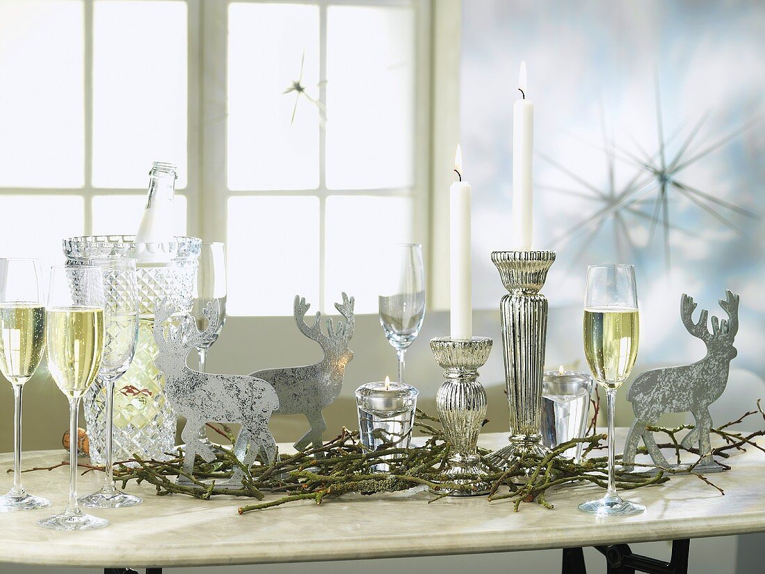 Silver decorations and sparkling wine on a Christmassy table