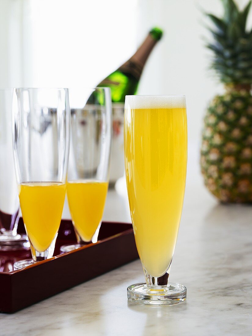 Three pineapple and sparkling wine cocktails