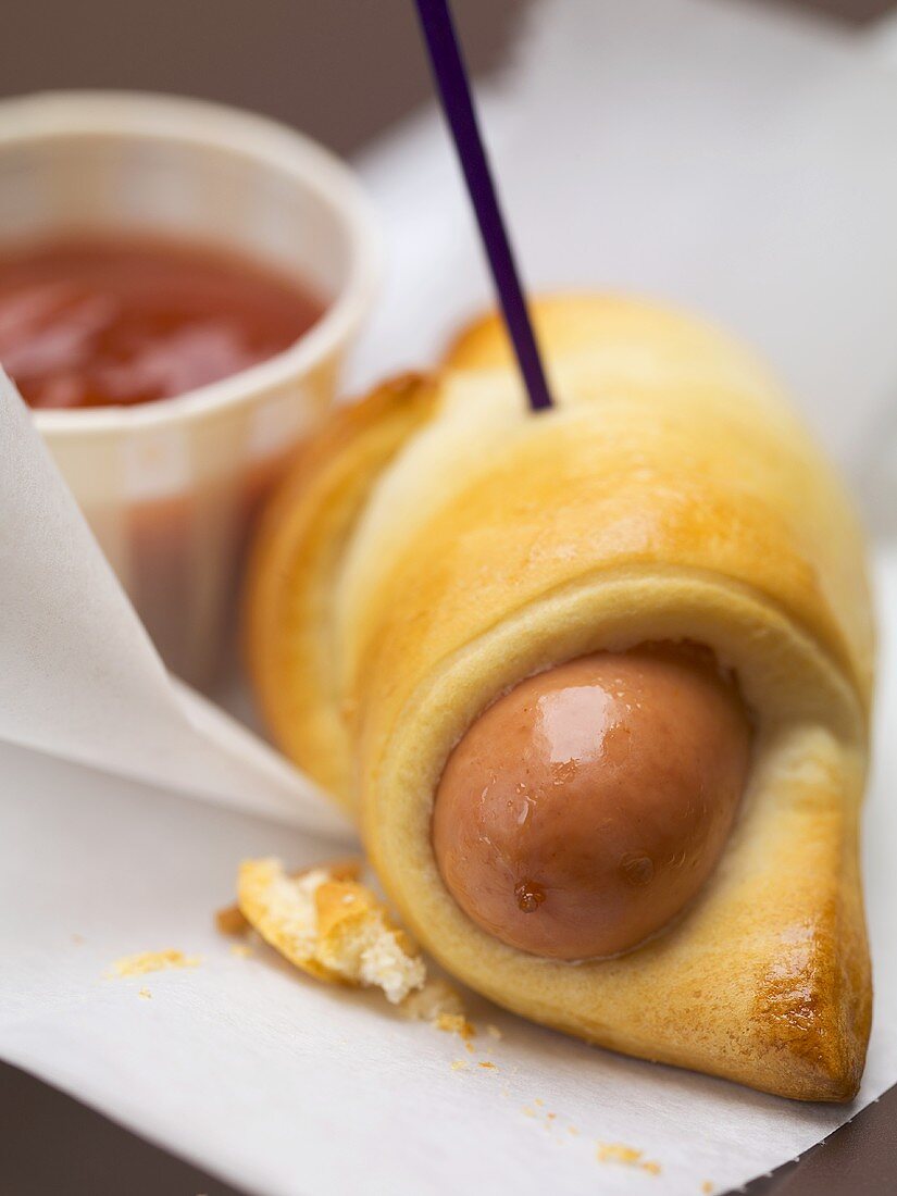 Sausage roll with ketchup