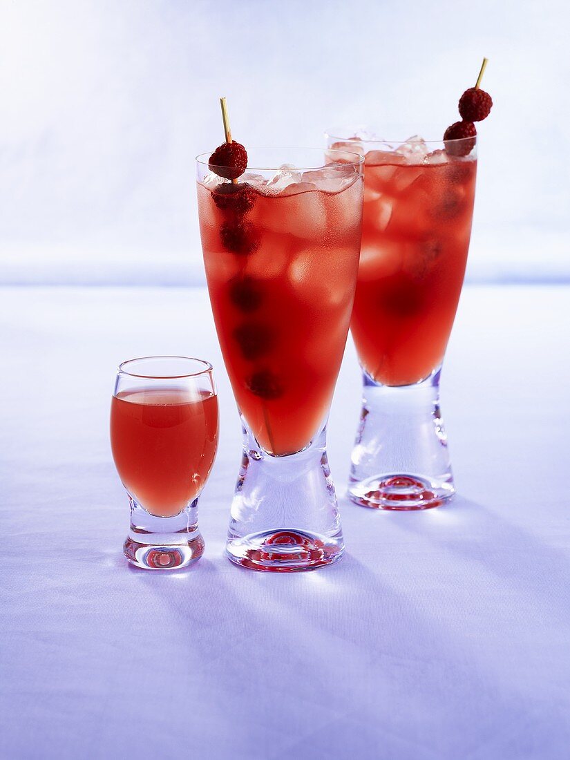 Raspberry drinks with raspberry skewers and ice cubes