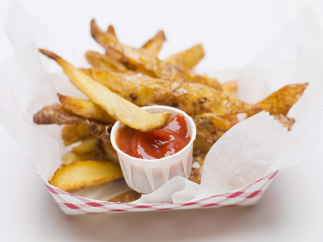 Chips in paper dish with ketchup