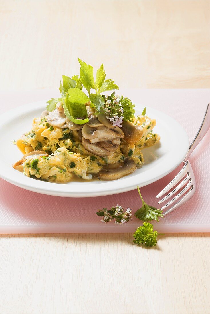Scrambled egg with fresh herbs and button mushrooms