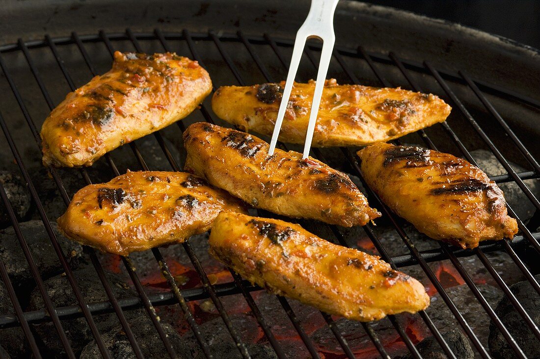 Marinated chicken breasts on a barbecue