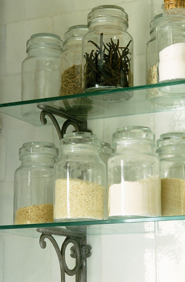 Storage jars on glass shelves