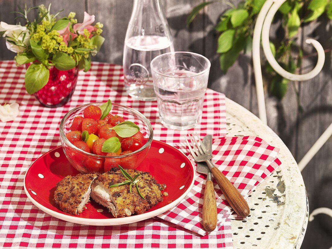 Cordon bleu stuffed with mozzarella with a tomato and melon salad