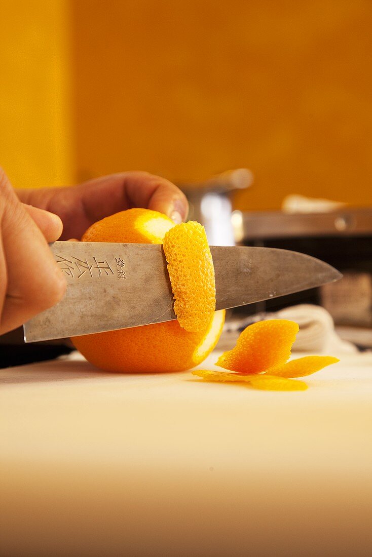 Peeling an orange with a knife