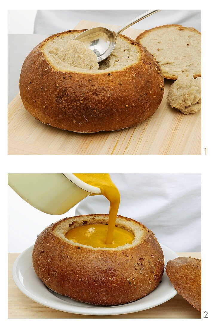 Cream of vegetable soup being served in a hollowed out loaf of bread