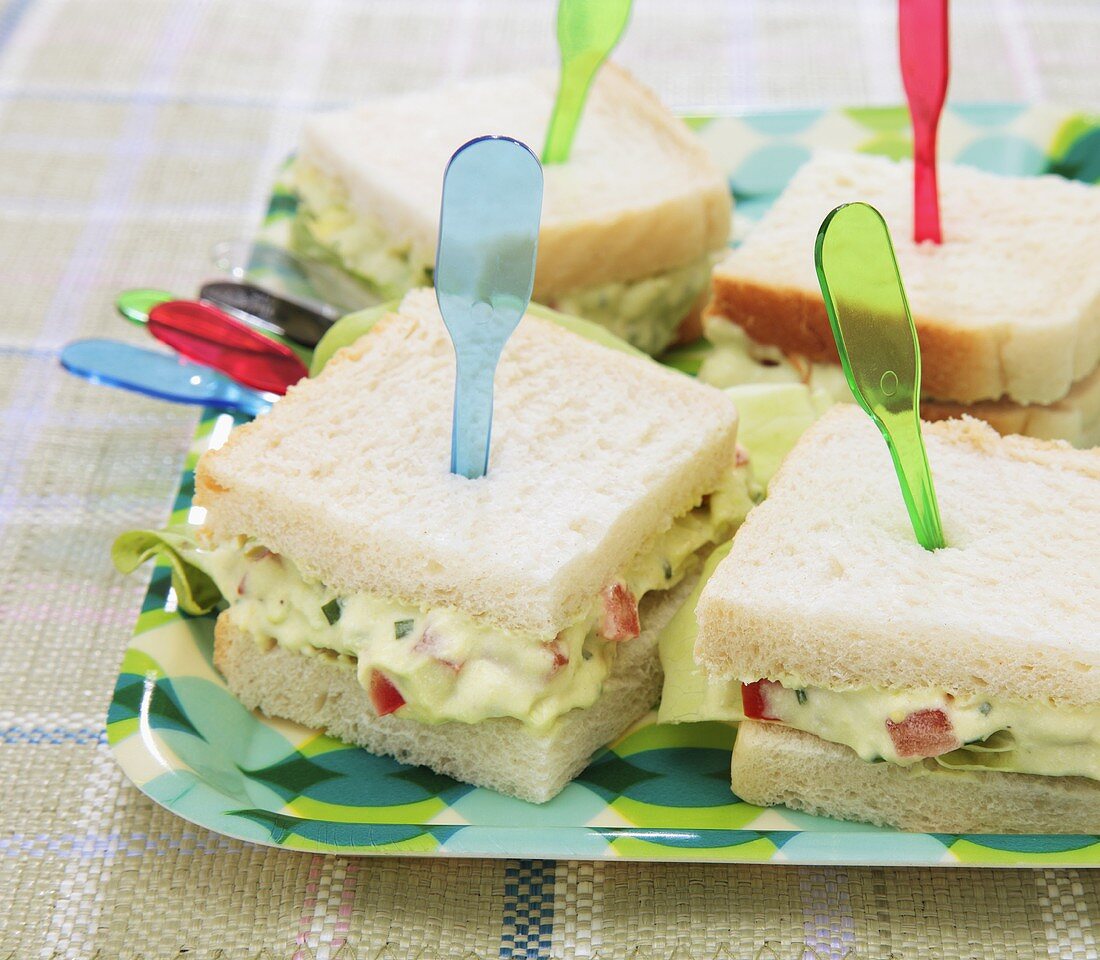 Mini avocado cream and tomato sandwiches