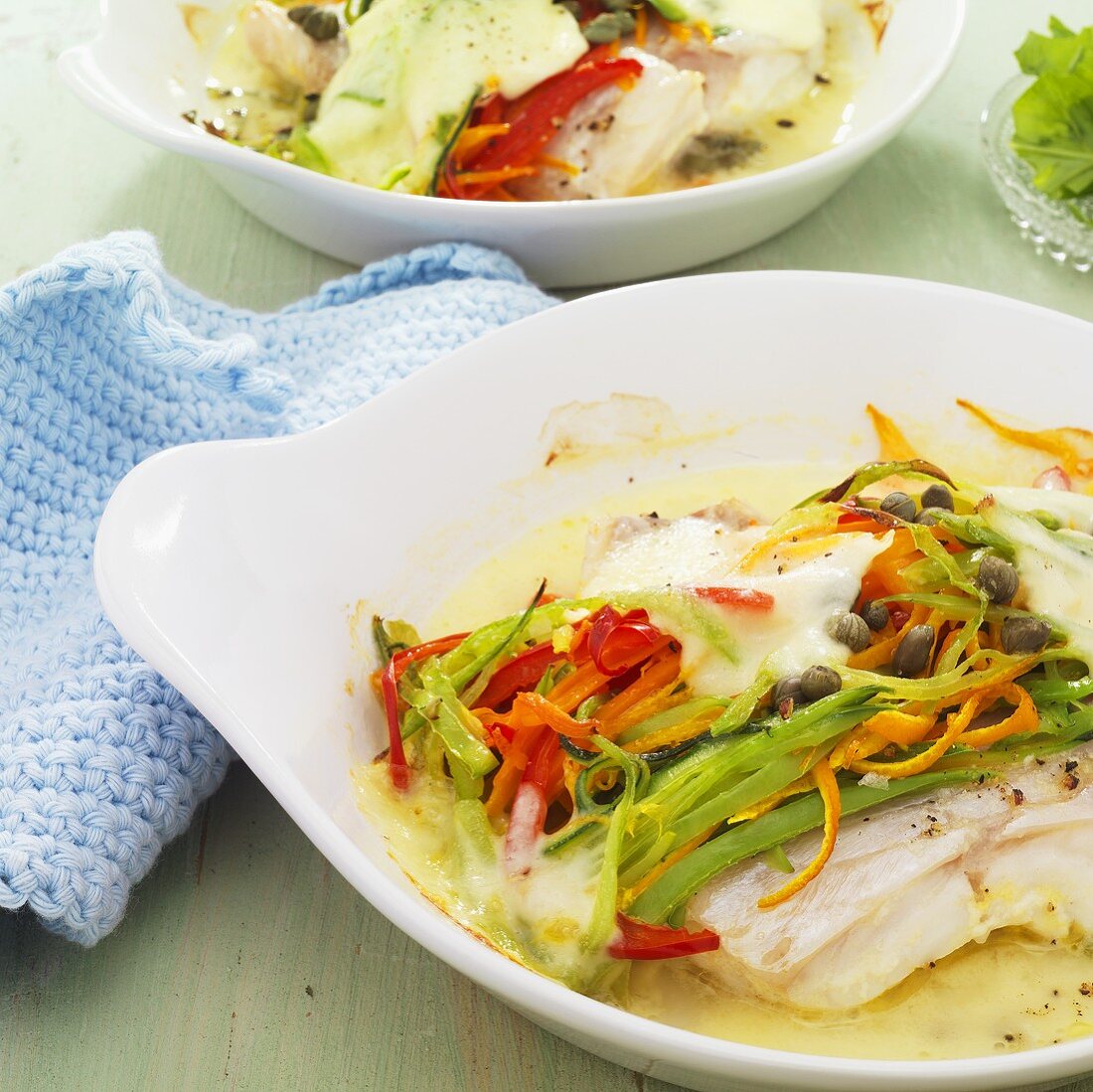 Fillet of fish with vegetables and melted mozzarella