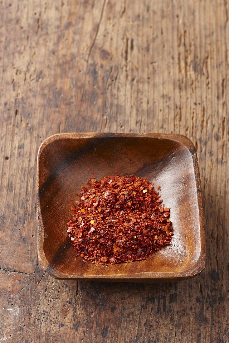 Chilli flakes in a wooden bowl
