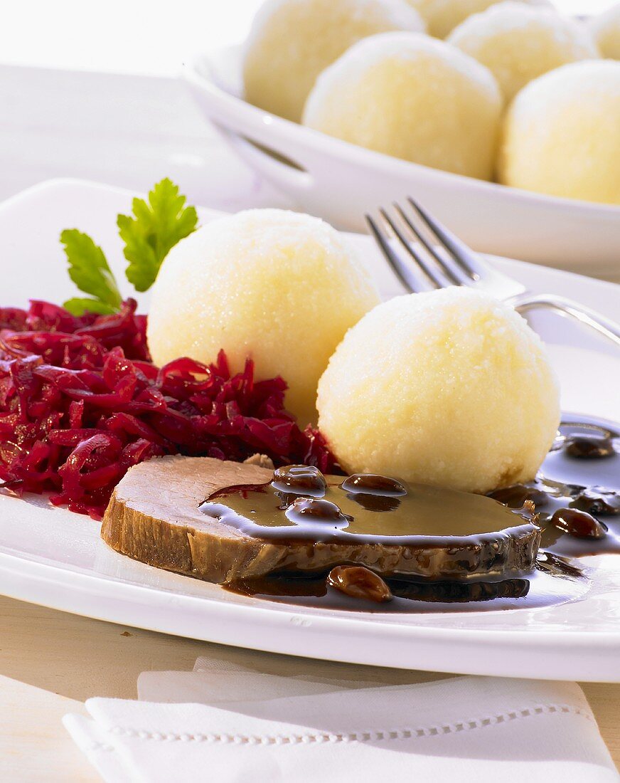 Rhineland-style Sauerbraten (marinated pot roast) with red cabbage and dumplings