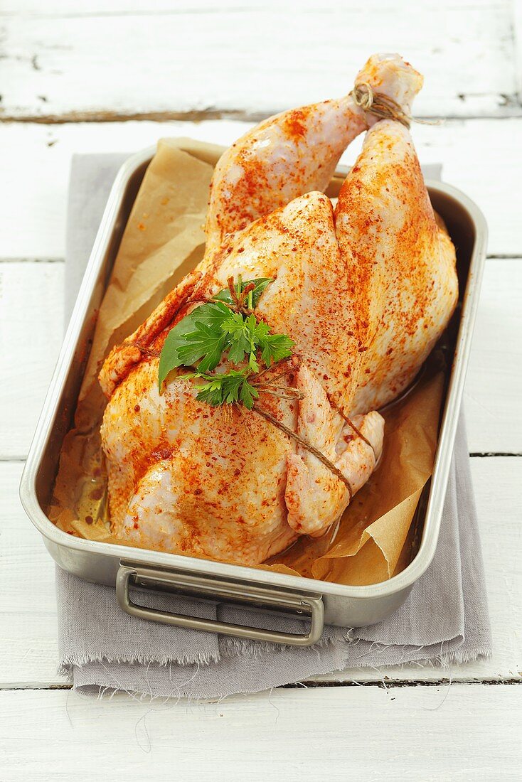 Spicy chicken with herbs in a roasting tin