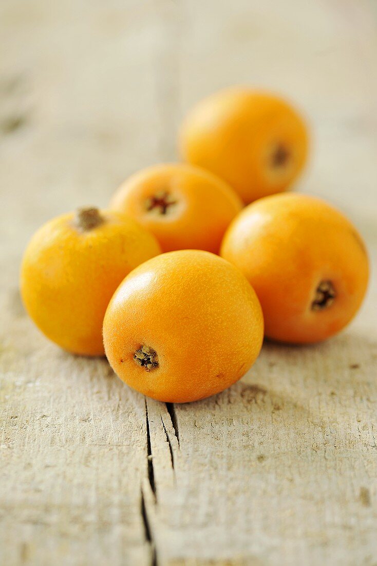 Medlars on a wooden surface