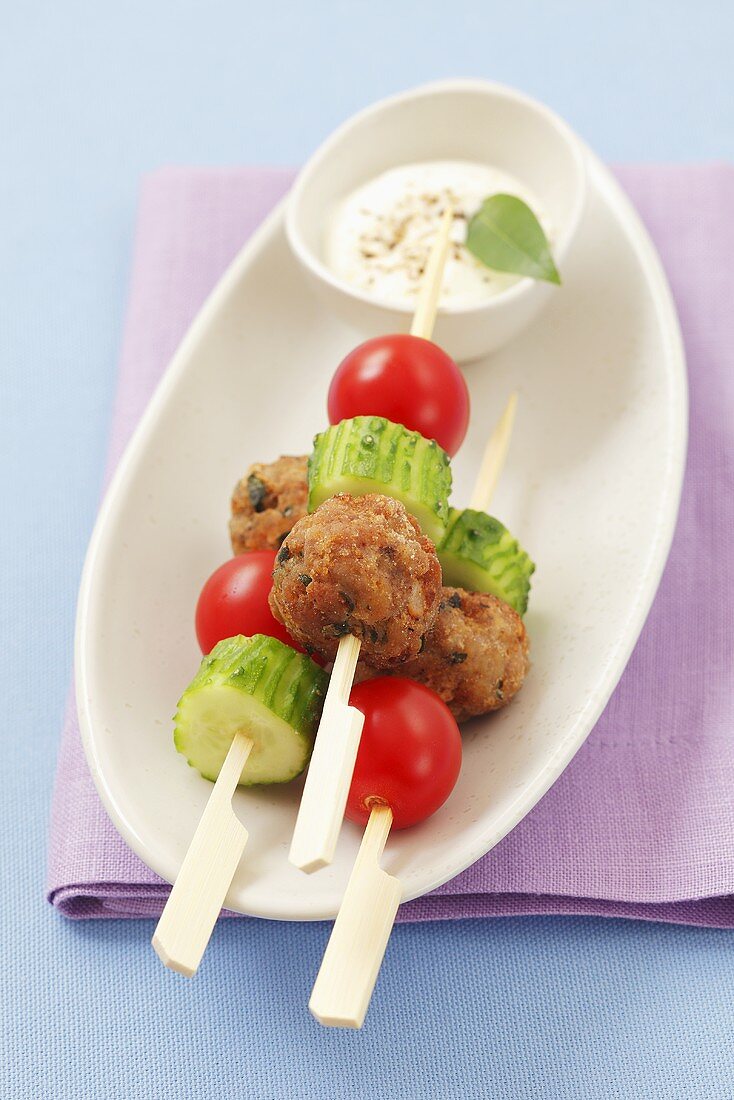 Kebabs with meatballs, cucumber and cherry tomatoes