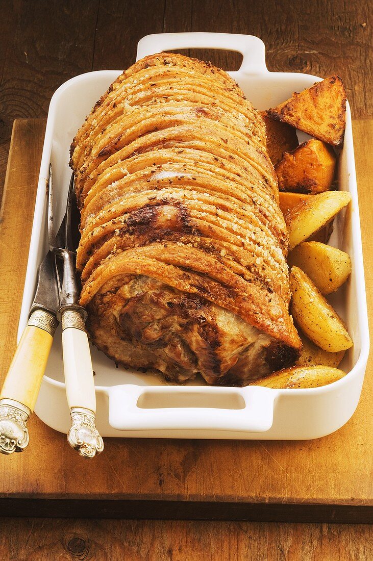 Roast pork with a side of vegetables in an oven-proof dish
