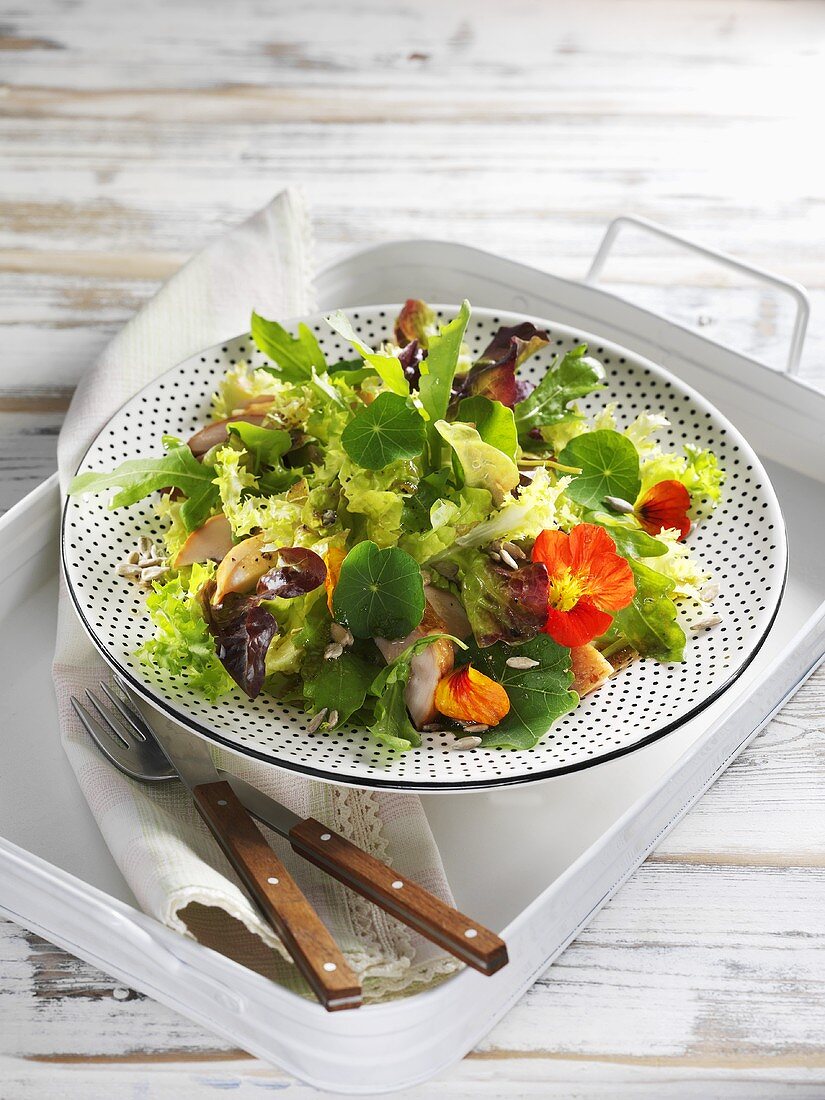 Mixed leaf salad with nasturtiums and smoked chicken breast