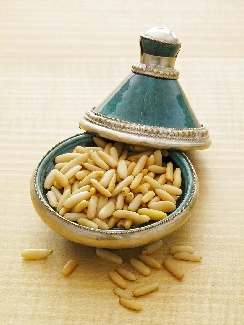 Lots of pine nuts in an oriental bowl