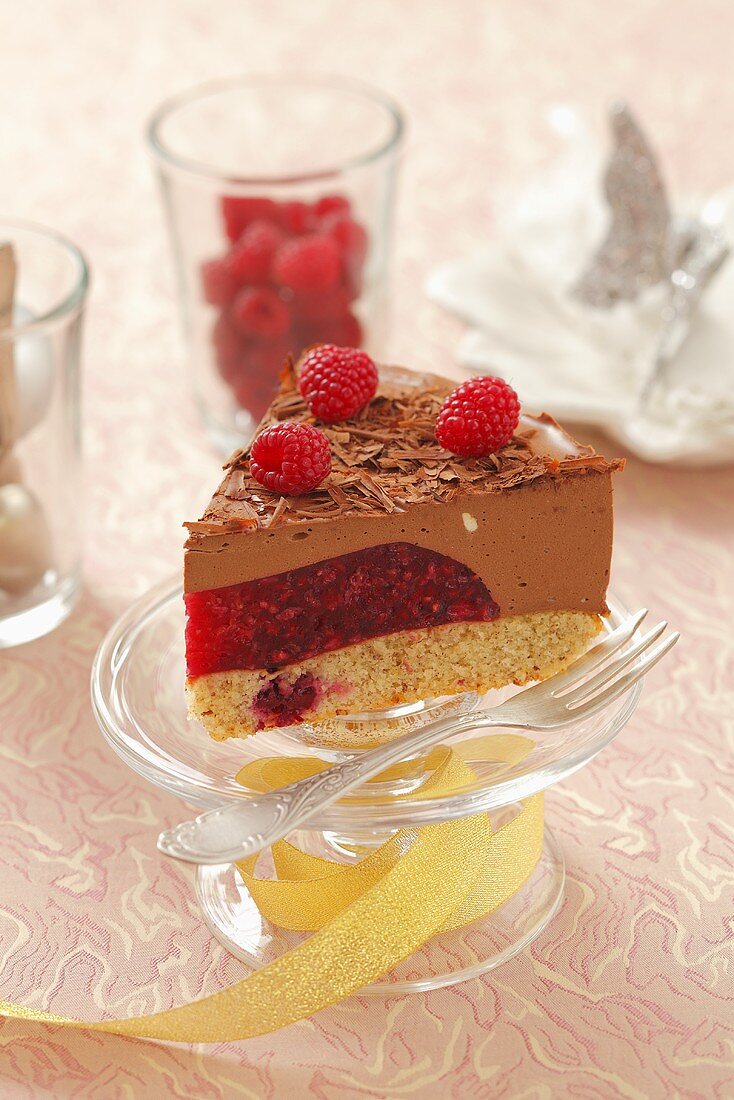 A piece of Christmas chocolate mousse tart with raspberries