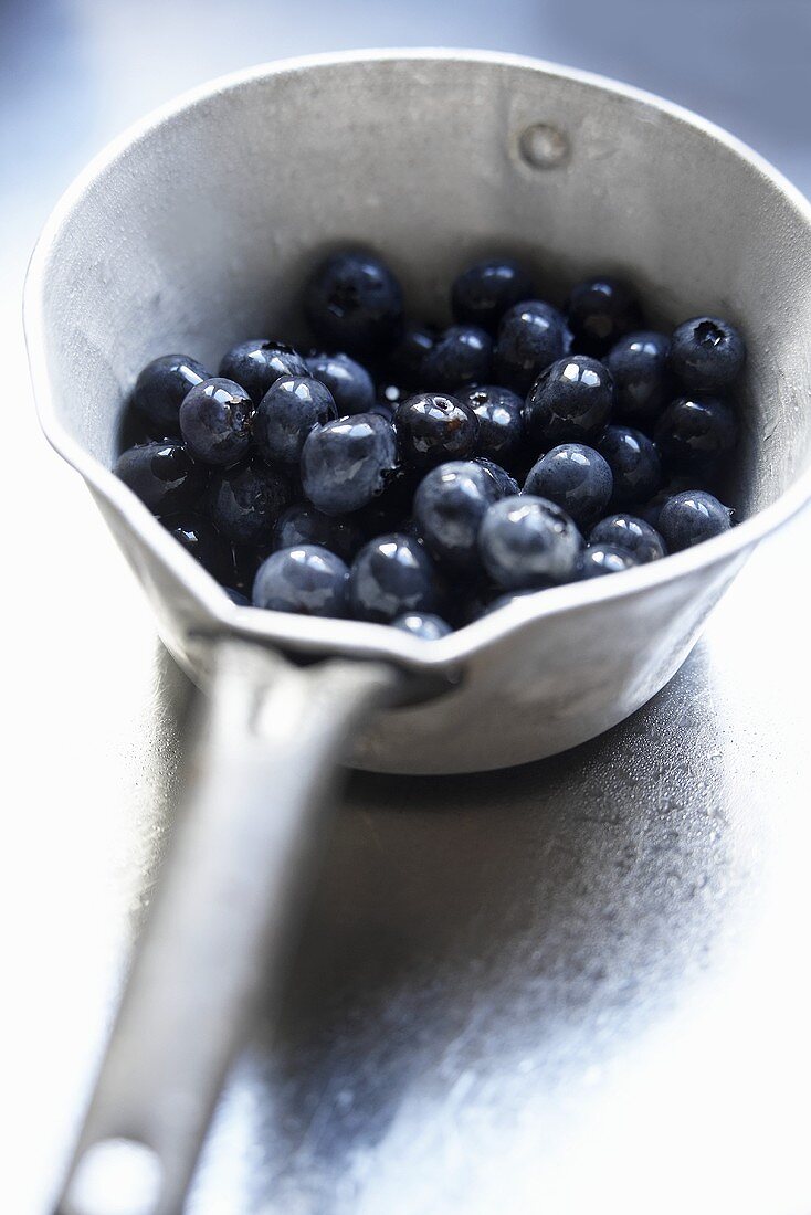 Freshly washed blueberries in an iron pot