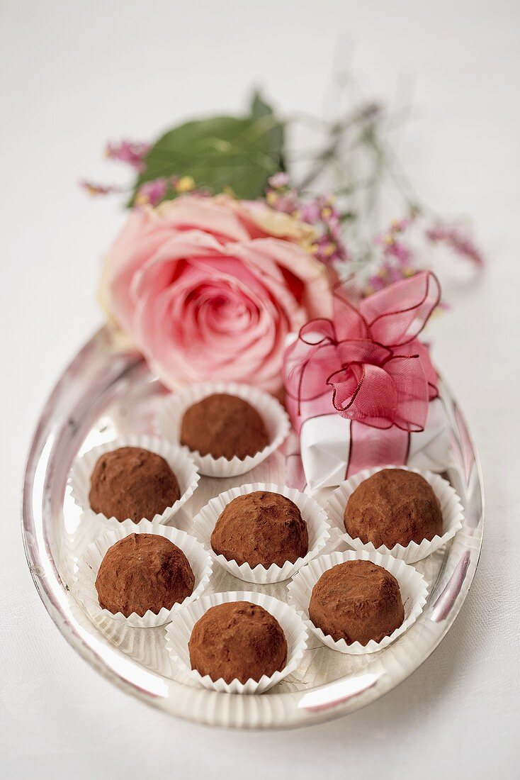 Truffle pralines on a silver tray decorated with flowers