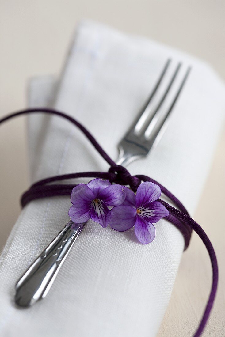 A napkin decorated with a scented violet