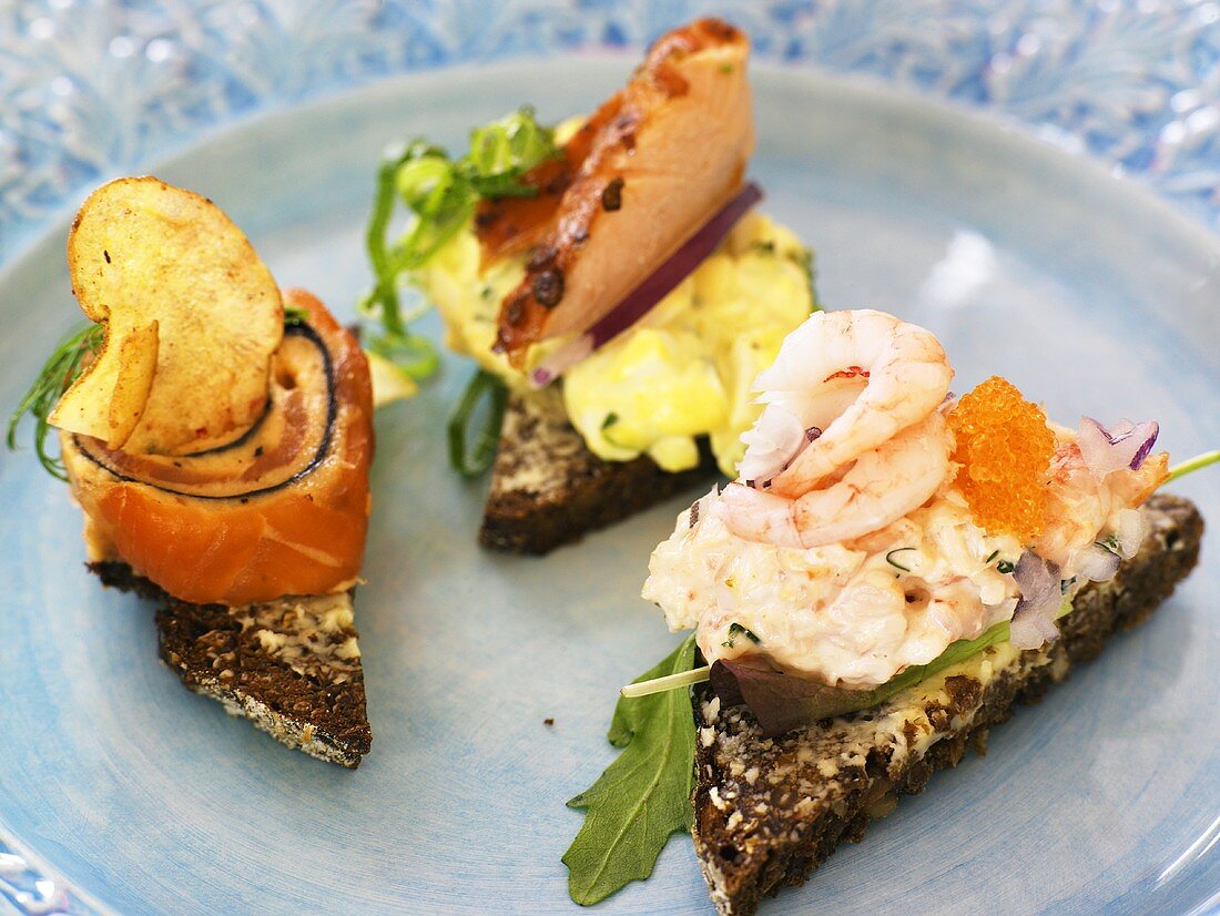 Canapes with salmon, scrambled egg and prawns
