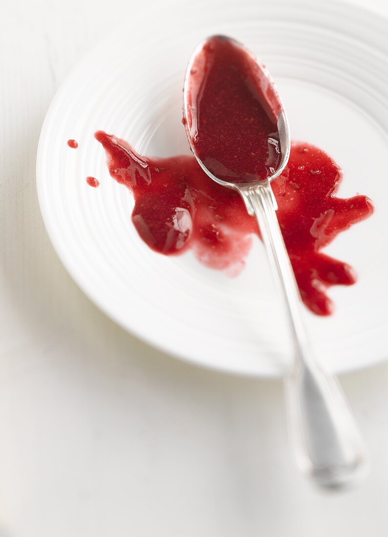 Fruit sauce on a plate and a spoon