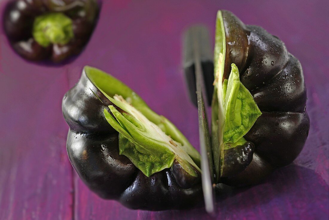 A purple pepper cut in half
