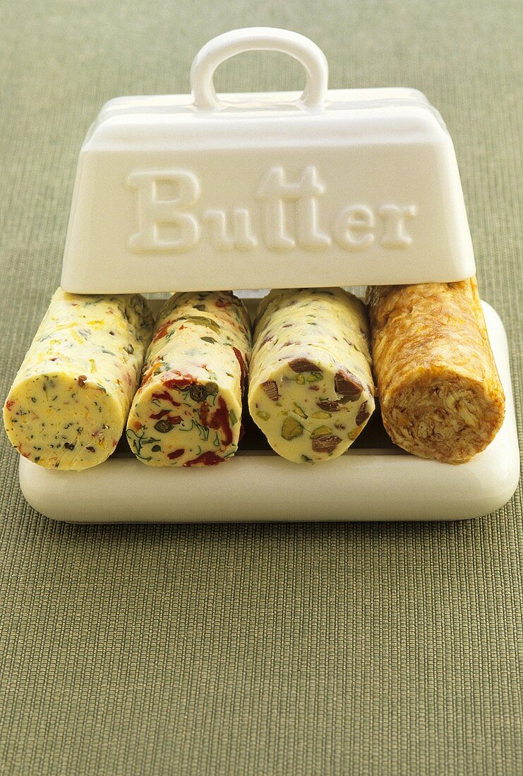 Various rolls of spiced butter