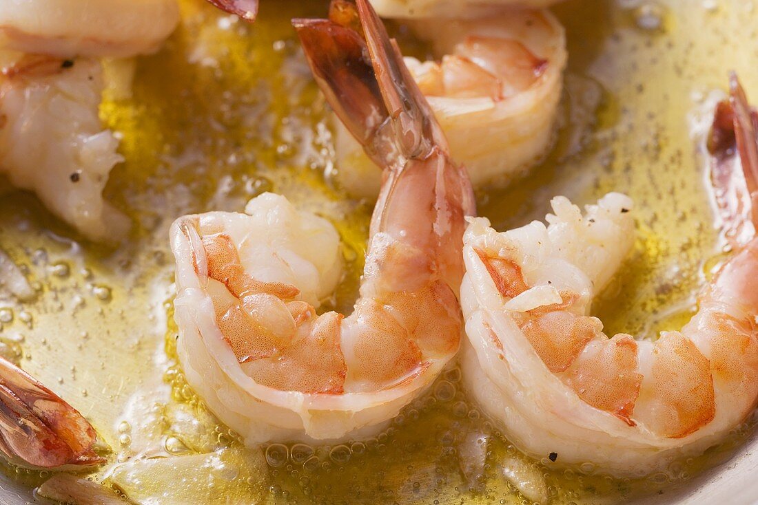 Prawns being fried with garlic