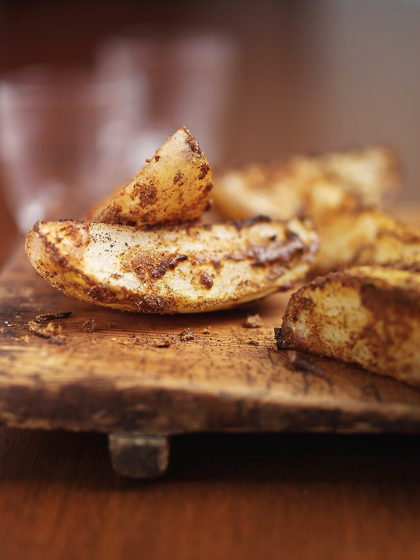 Potato wedges on a wooden board