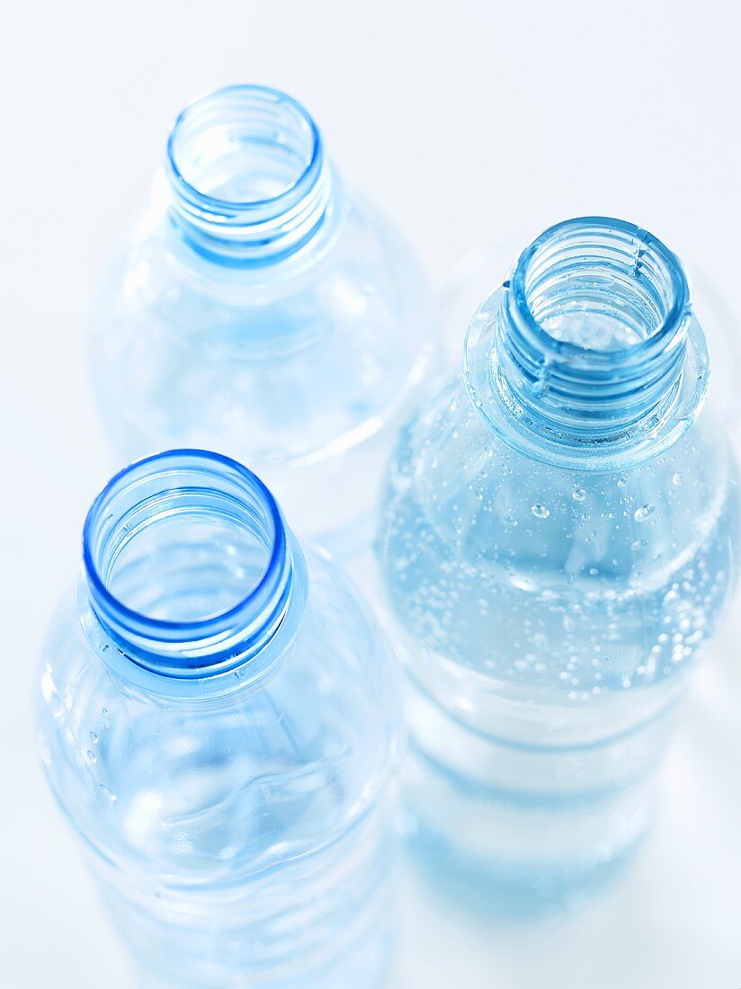 Three open bottles of water