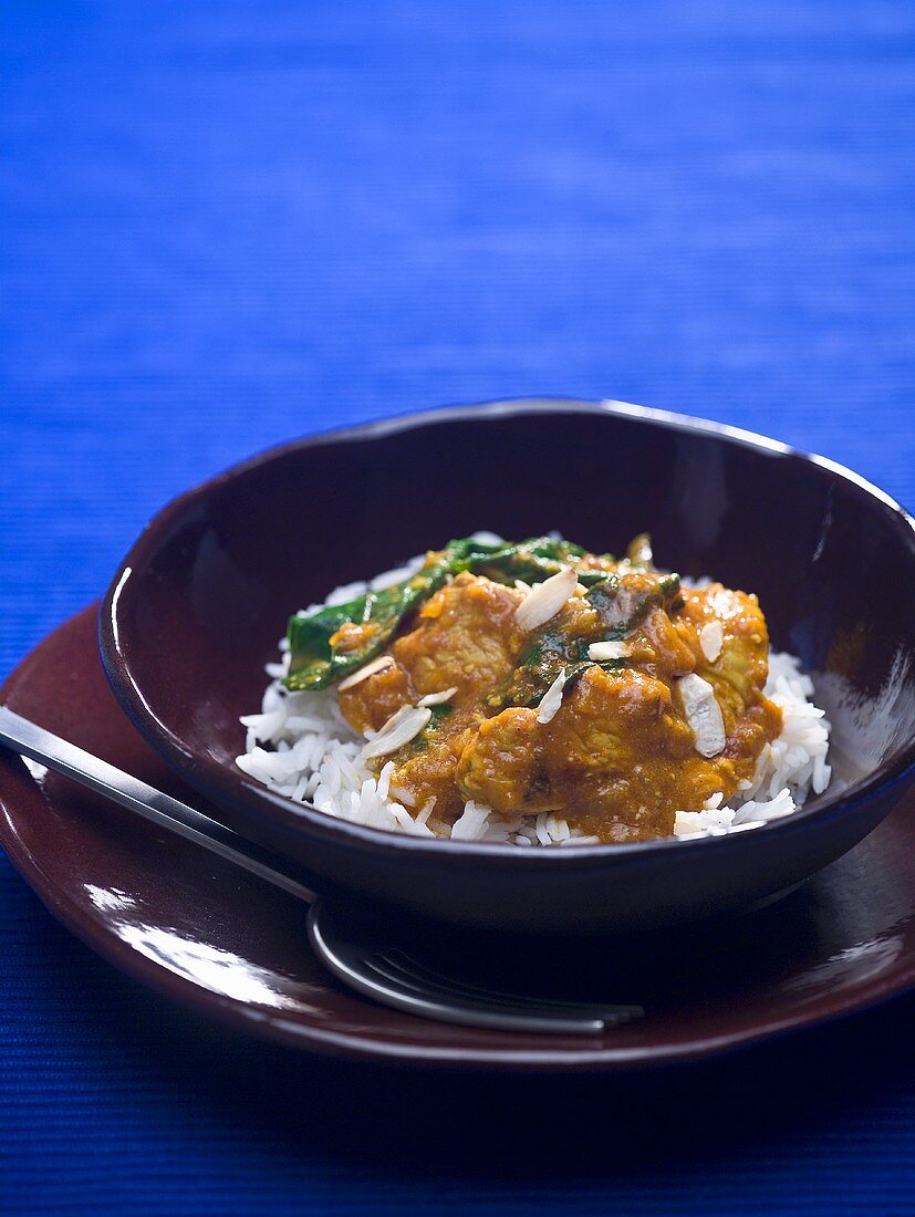 Turkey curry on rice in a small bowl