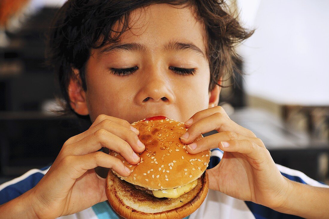 Boy eating hamburger