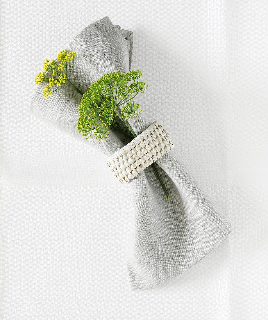 Fabric napkin with napkin ring and dill