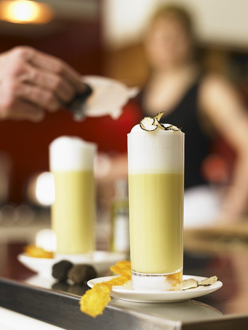 Potato soup with truffles and milk foam in glasses