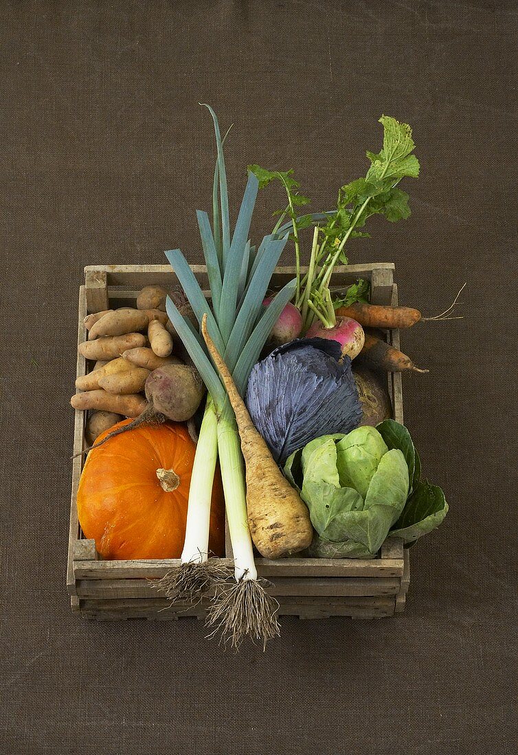 Assorted vegetables in wooden box