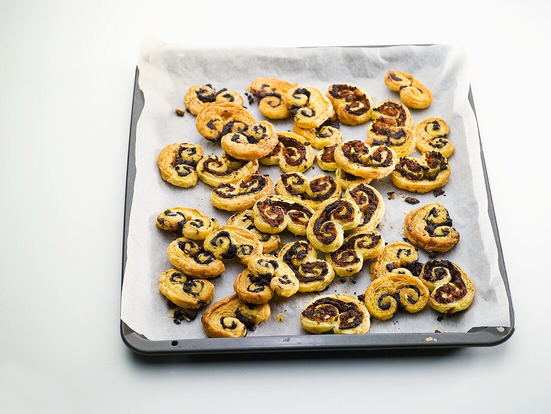Palmiers with tapenade on a baking tray