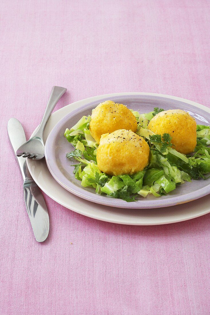 Polenta dumplings on cabbage