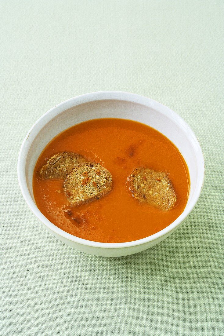 Cold red pepper soup with bread chips