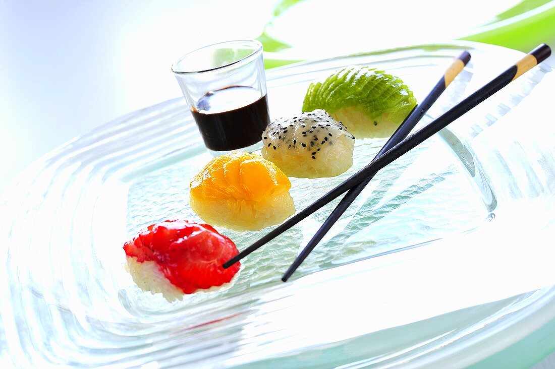 Sushi with strawberries, mango, pitahaya & kiwi, chocolate sauce