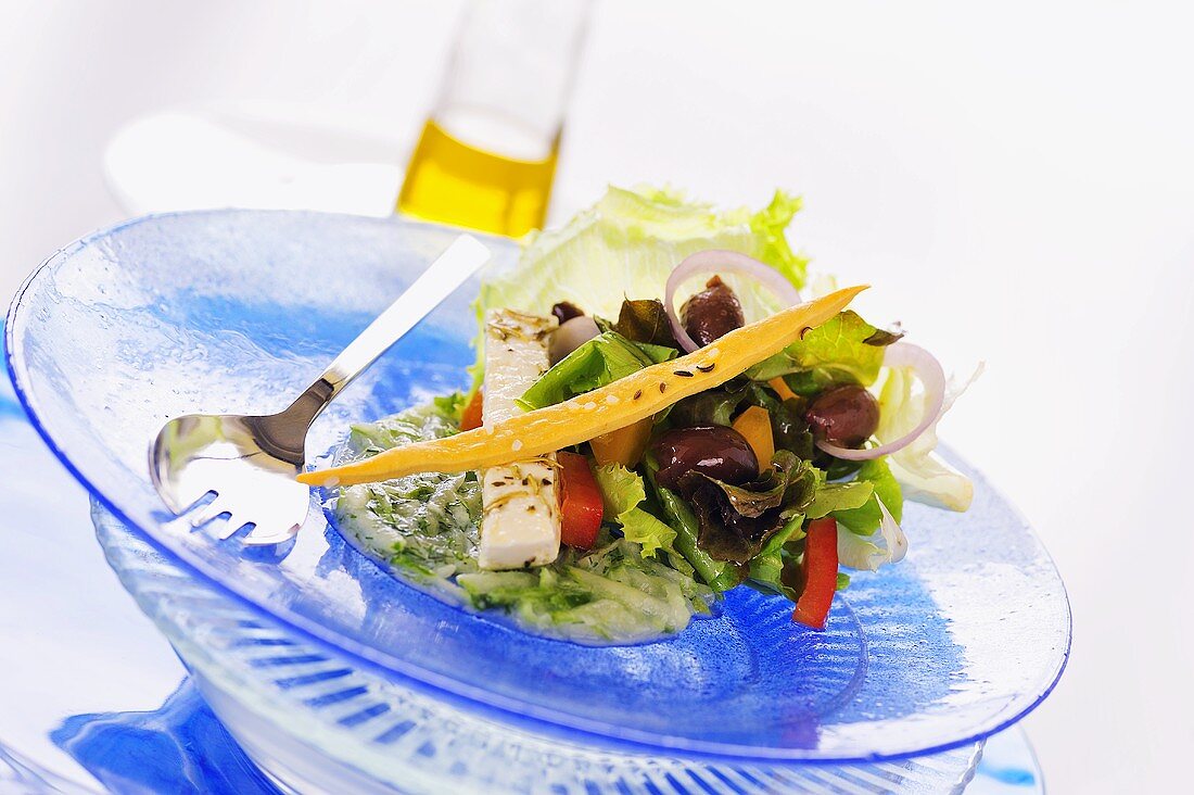 Salad leaves with marinated feta and olives