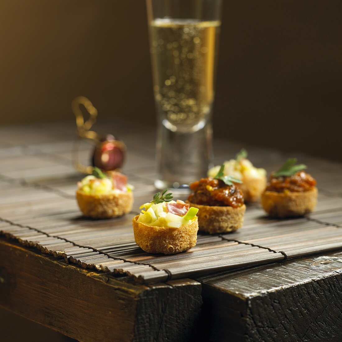 Pancetta & leek and aubergine & caviar tartlets with sparkling wine