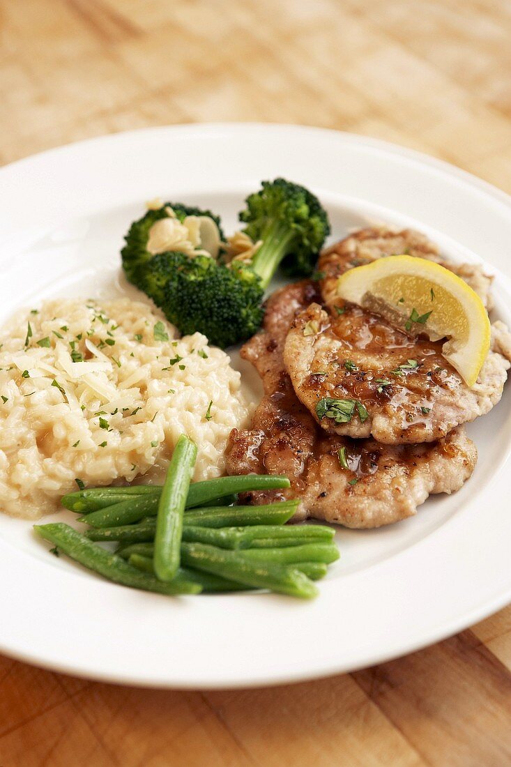 Veal escalopes with risotto, green beans and broccoli
