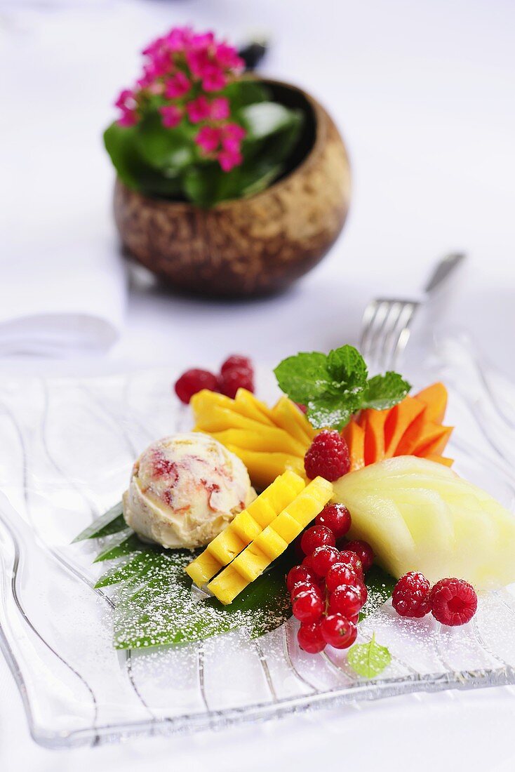 Exotic fruit salad with berries and coconut fruit ice cream