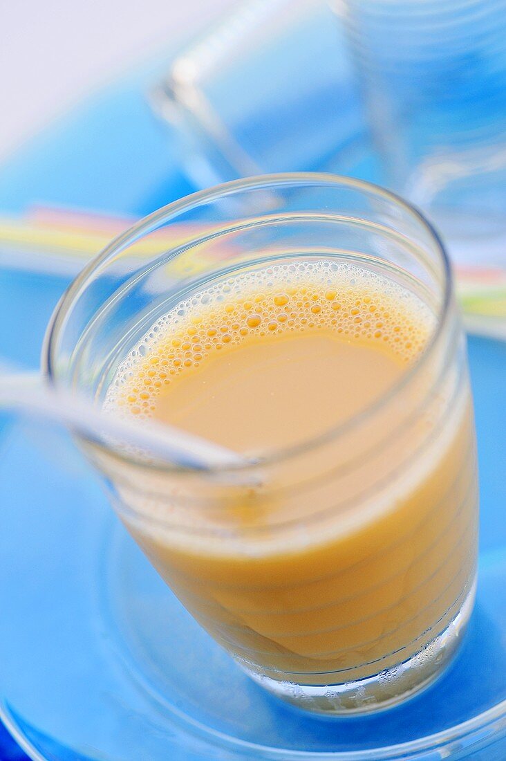 A glass of soya milk with straw