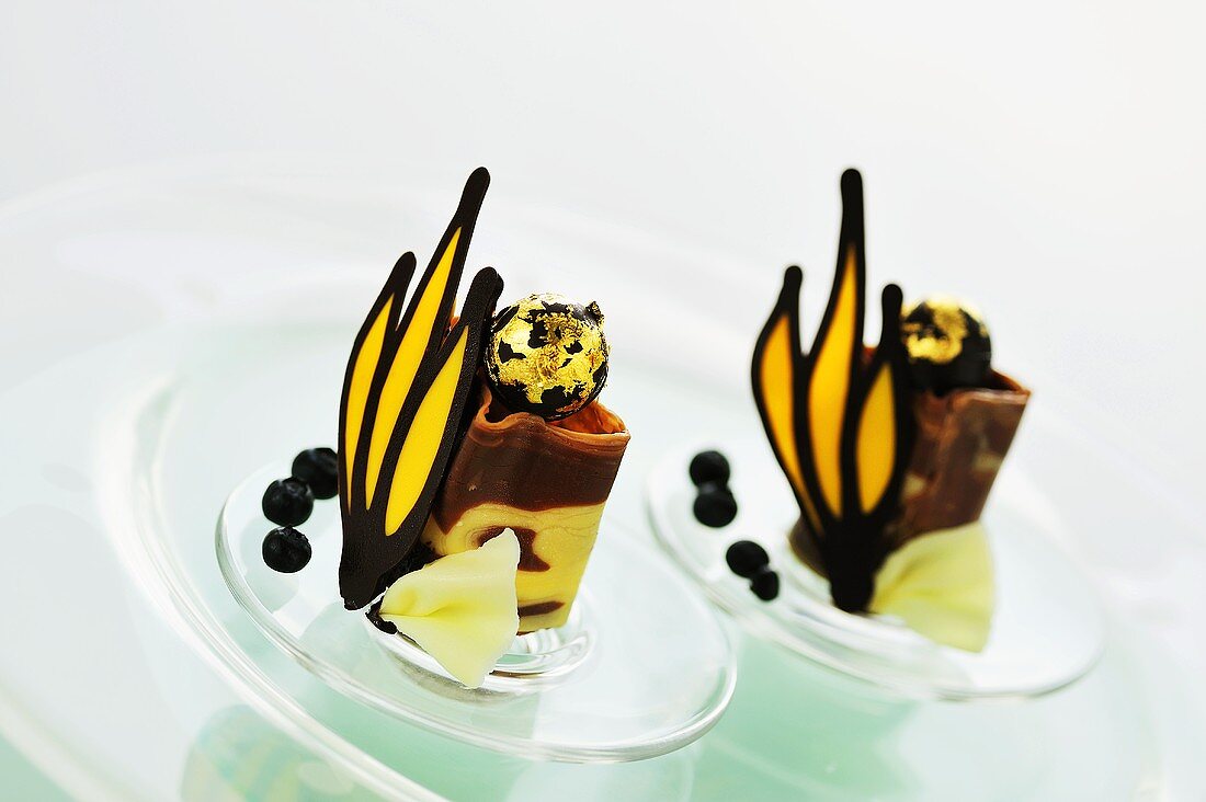 Two chocolate desserts with gilded chocolates