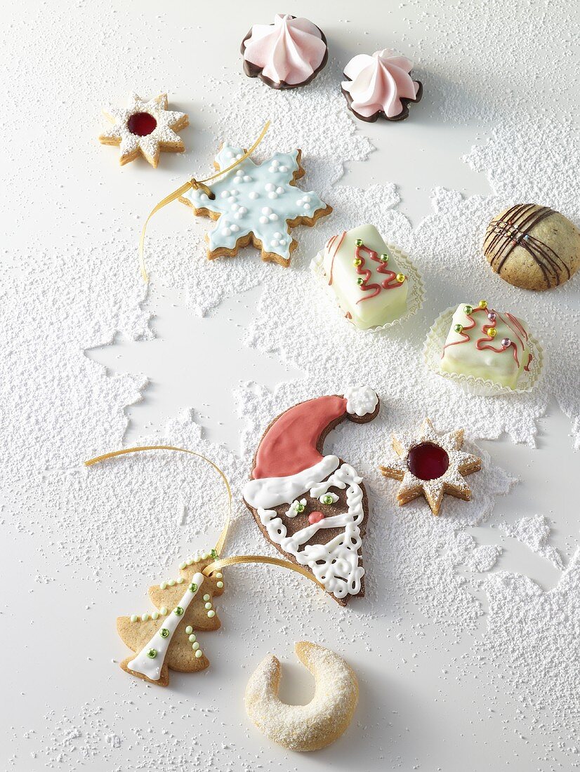 Assorted Christmas biscuits on icing sugar