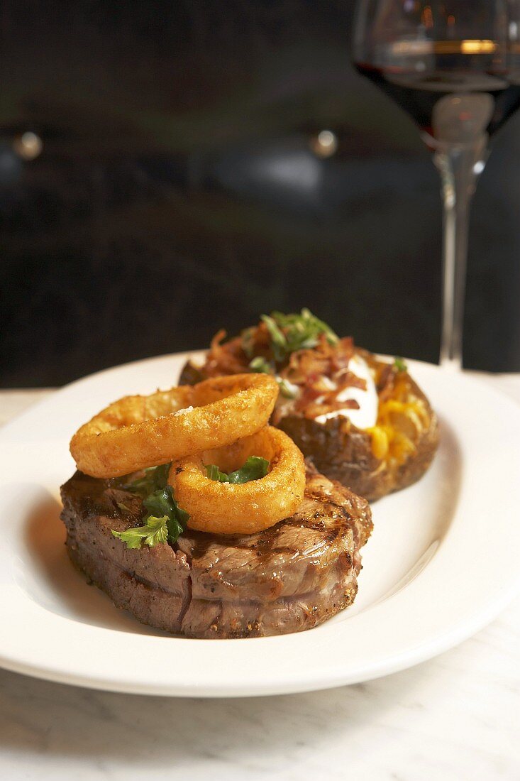 Grilled rib eye steaks with deep-fried onion rings